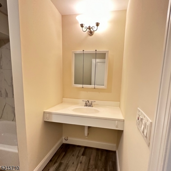 290 3rd Street, Unit D1 Hackensack, NJ 07601 - Photo 17 of 21 a bathroom with a sink and a mirror