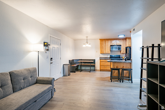 1221 Waterside Cove, Unit 11 Midvale, UT 84047 - Photo 2 of 23 Open-concept living area featuring light wood-finish flooring