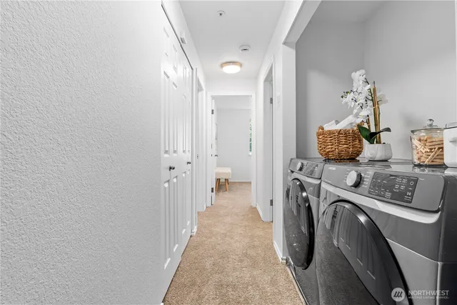 a view of a storage & utility room with a washer dryer