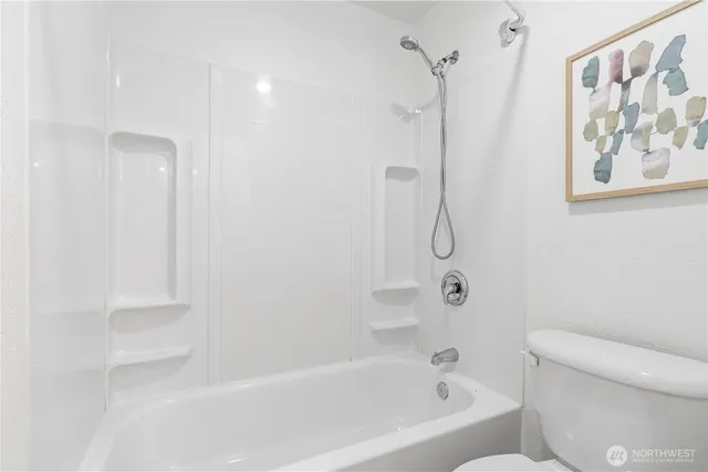a bathroom with a bath tub with a shower