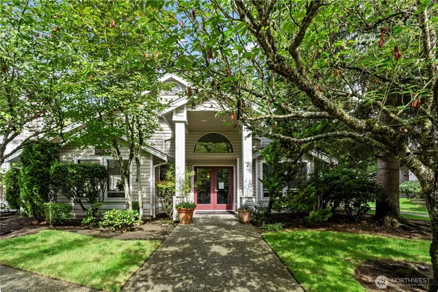 a view of a house with a tree in a garden