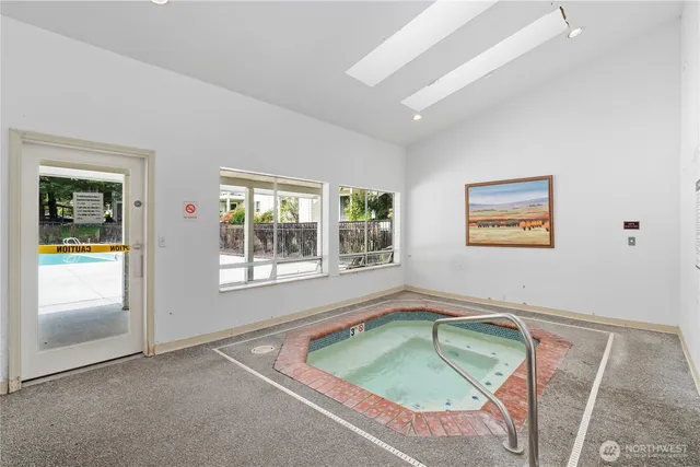 a bathroom with a tub sink and window