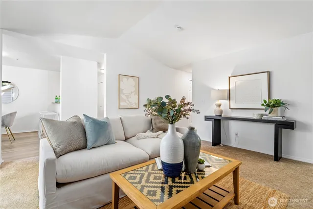 a living room with furniture a window and a table