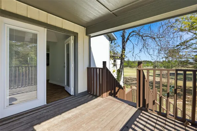 a view of balcony with wooden floor