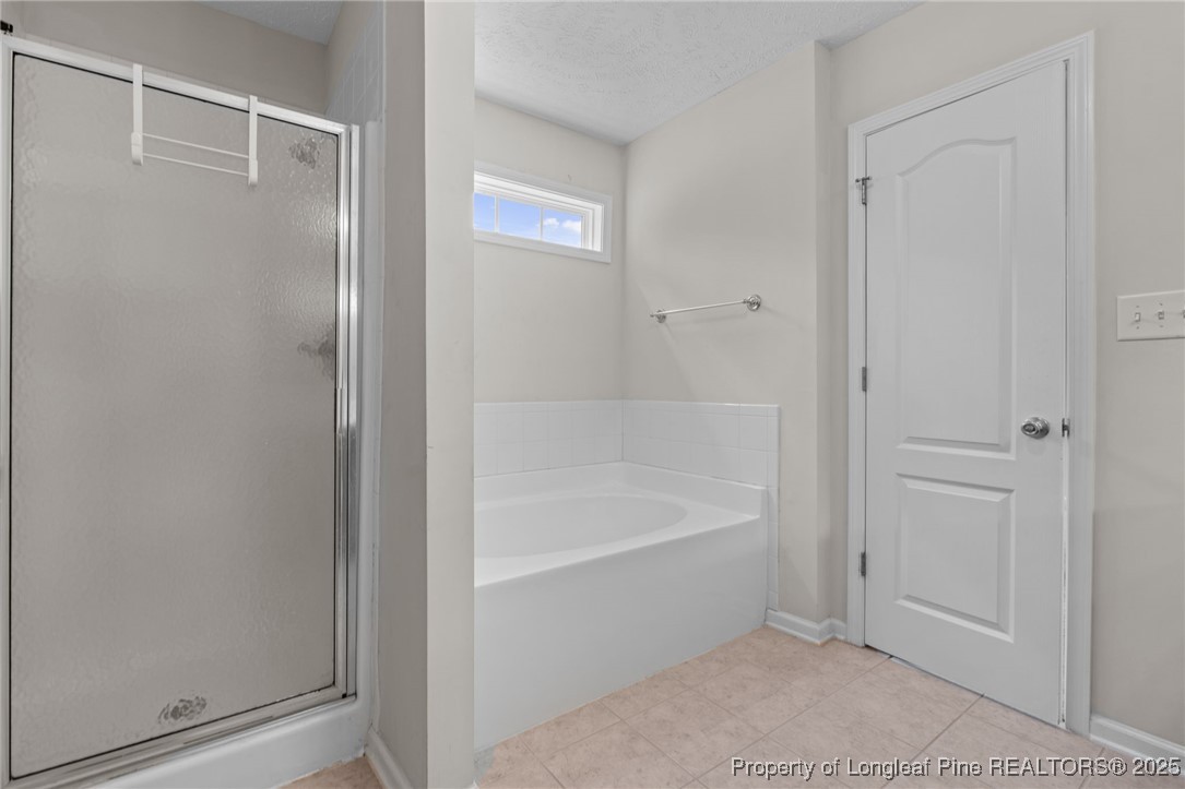 117 Usher Court Raeford, NC 28376 - Photo 26 of 48 a bathroom with a bathtub and a shower