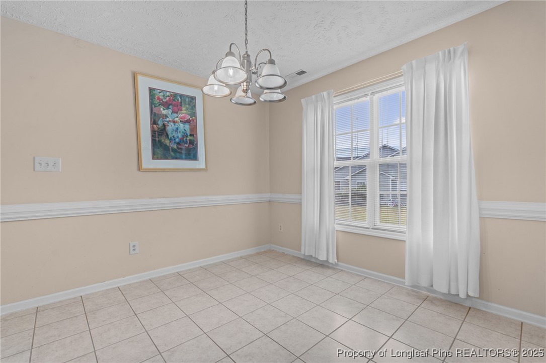 117 Usher Court Raeford, NC 28376 - Photo 42 of 48 an empty room with windows and chandelier