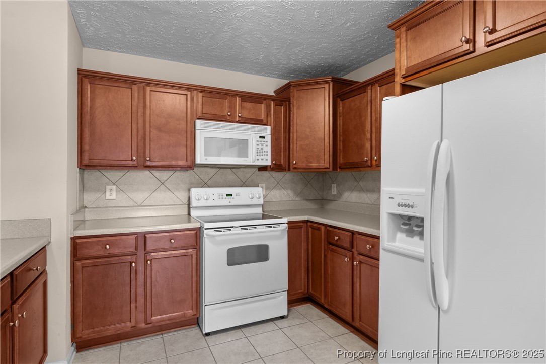 117 Usher Court Raeford, NC 28376 - Photo 45 of 48 a kitchen with stainless steel appliances granite countertop a stove sink and refrigerator
