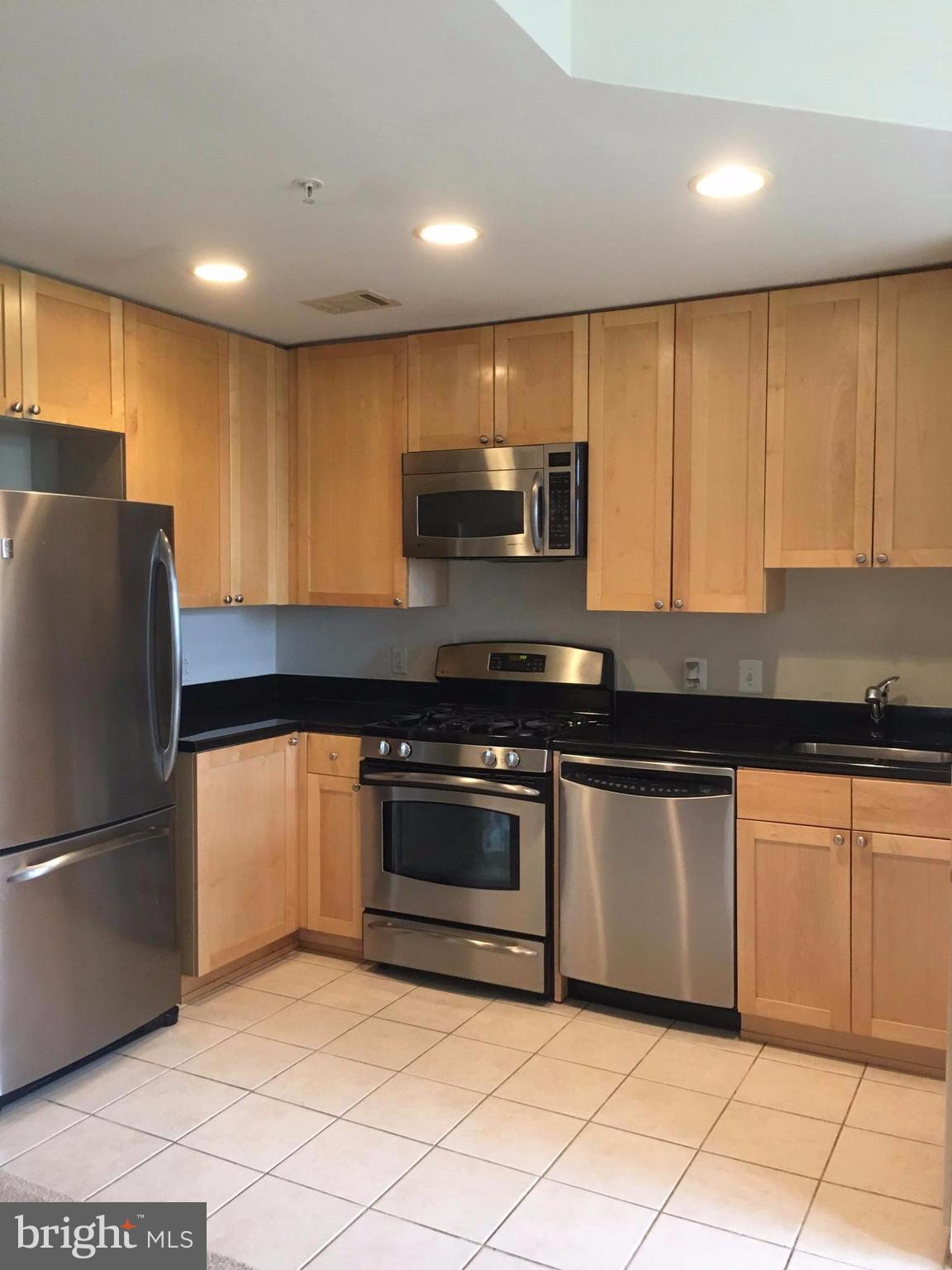 3600 South Glebe Road, Unit 330W Arlington, VA 22202 - Photo 3 of 20 a kitchen with granite countertop a refrigerator and a sink