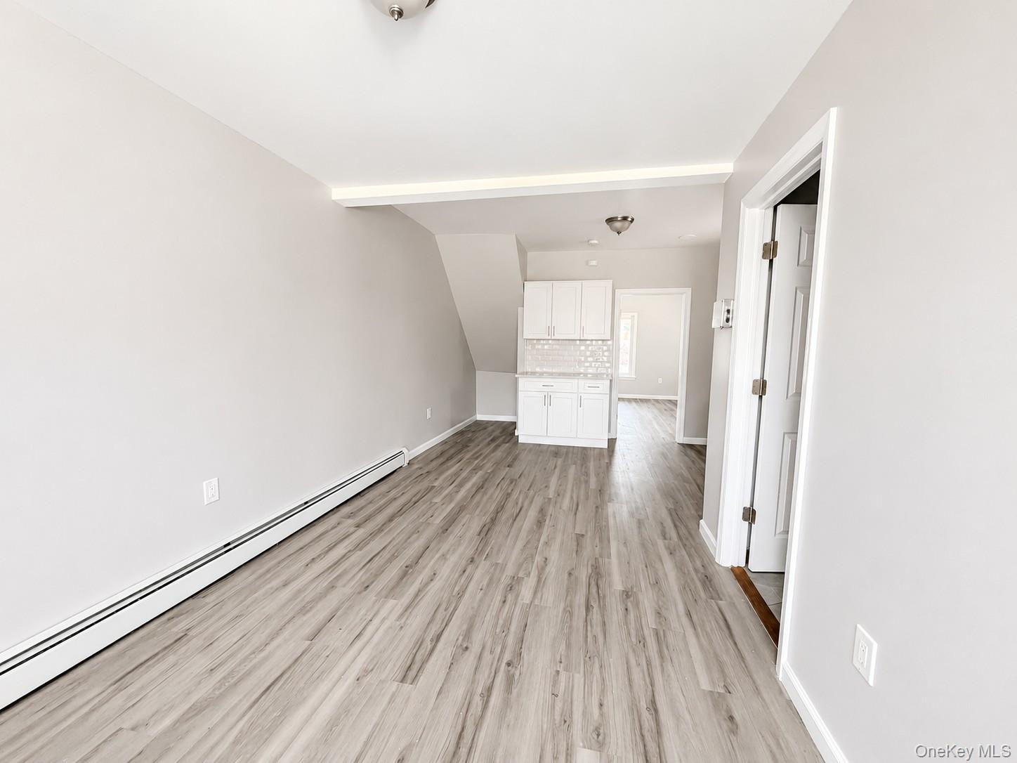 25 Monroe Street, Unit 1 Mount Vernon, NY 10550 - Photo 3 of 11 Open concept living area featuring wood-finish flooring, light gray wall tones, and white baseboards