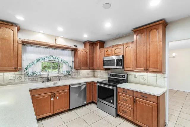 a spacious bathroom with a granite countertop tub sink and mirror