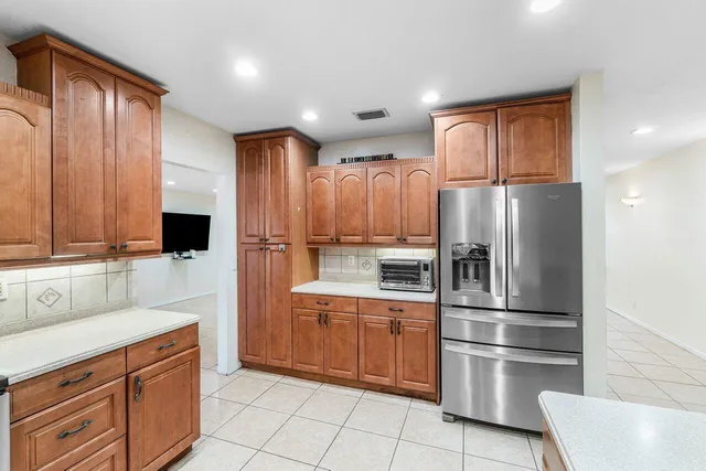 a view of a house with a yard and potted plants