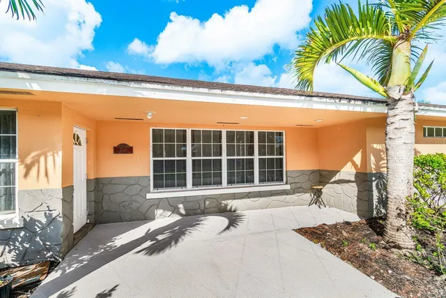 an aerial view of residential house with outdoor space and trees all around