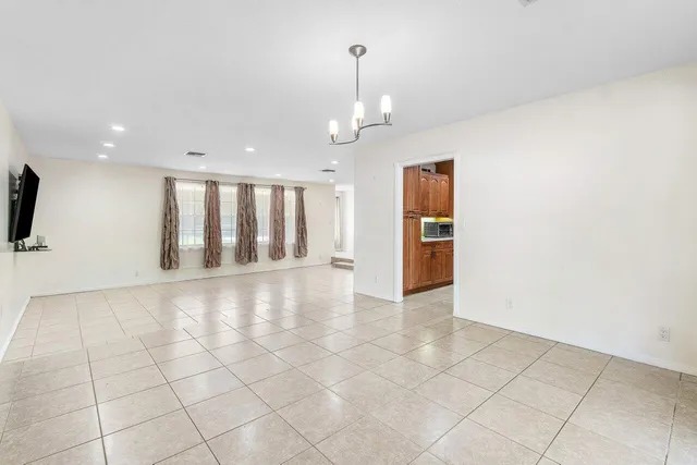 a kitchen with stainless steel appliances kitchen island granite countertop a sink and cabinets