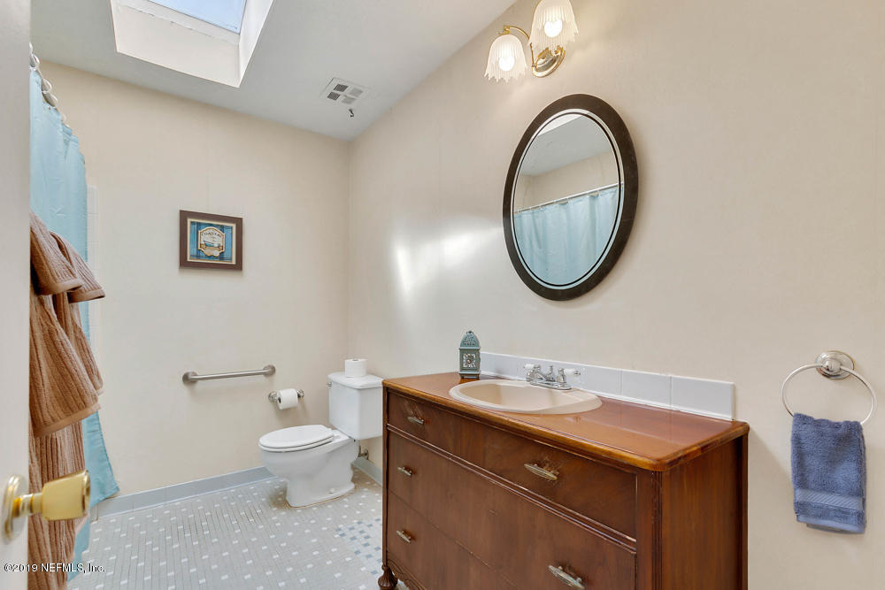 112 Faun Road St. Augustine, FL 32086 - Photo 17 of 36 a bathroom with a toilet a sink and a mirror