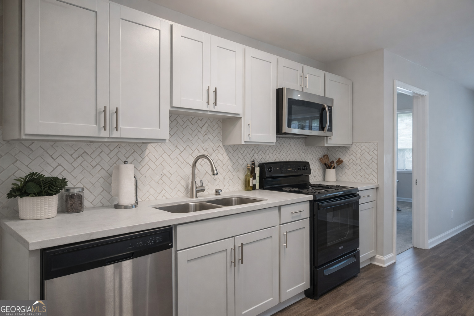 154 Glynn Addy Drive Stockbridge, GA 30281 - Photo 2 of 4 a kitchen with white cabinets and a stove top oven
