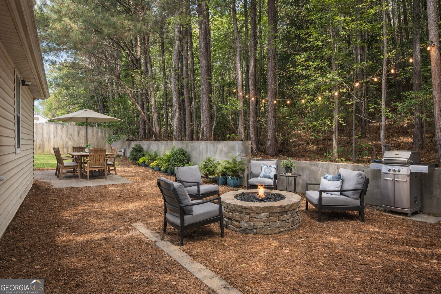 154 Glynn Addy Drive Stockbridge, GA 30281 - Photo 3 of 4 a view of a patio with furniture and a fire pit