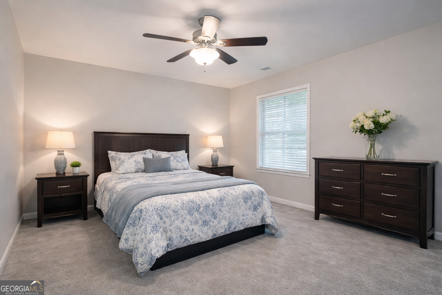 154 Glynn Addy Drive Stockbridge, GA 30281 - Photo 4 of 4 a bedroom with a bed a chandelier and a dresser