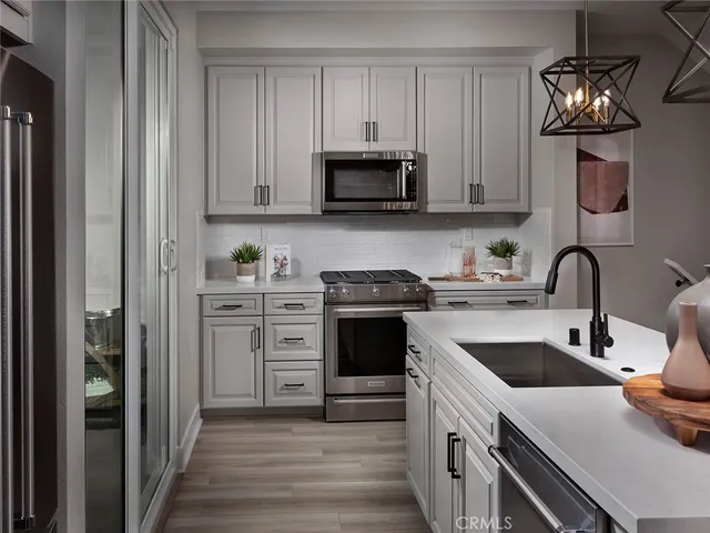 a kitchen with stainless steel appliances granite countertop a white stove top oven a sink and dishwasher