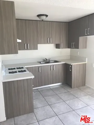 a kitchen with kitchen island cabinets and refrigerator