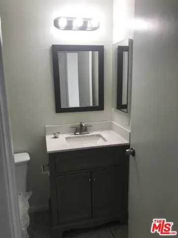 a bathroom with a sink vanity and a mirror
