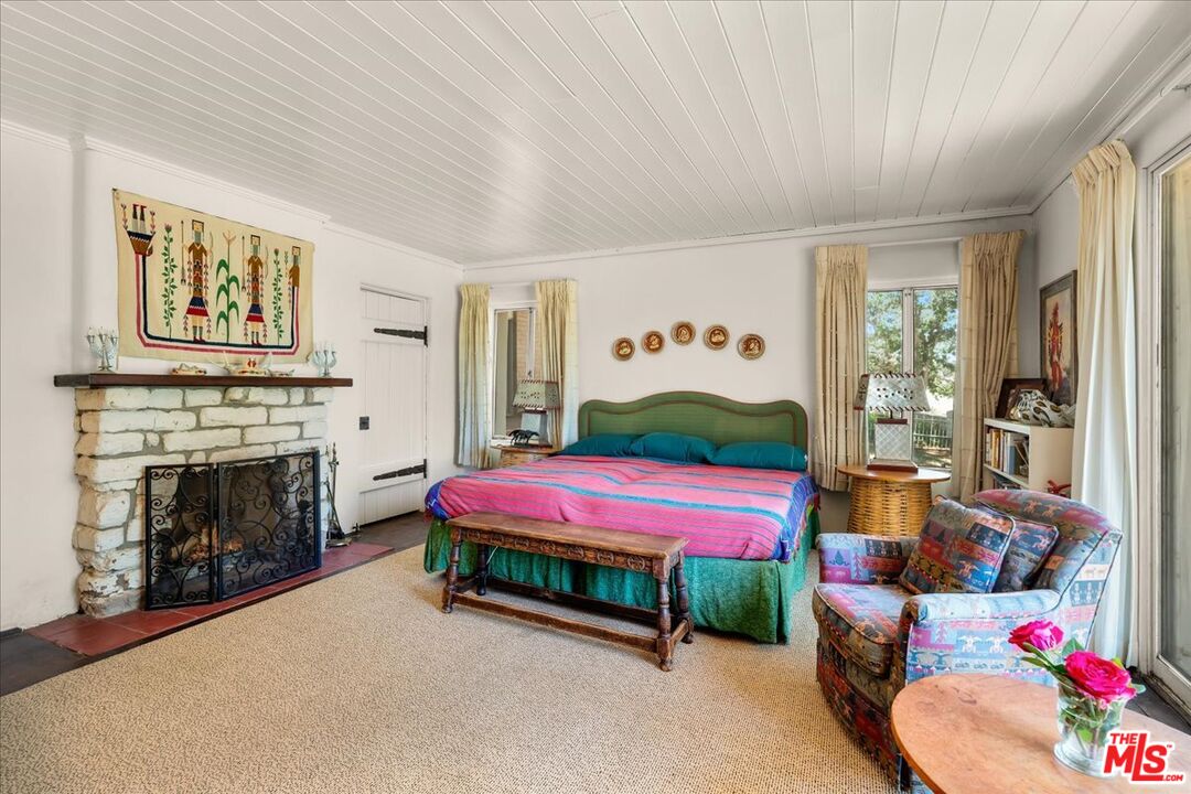 31008 Pine Canyon Road Lake Hughes, CA 93532 - Photo 11 of 29 a bedroom with a bed and a fireplace