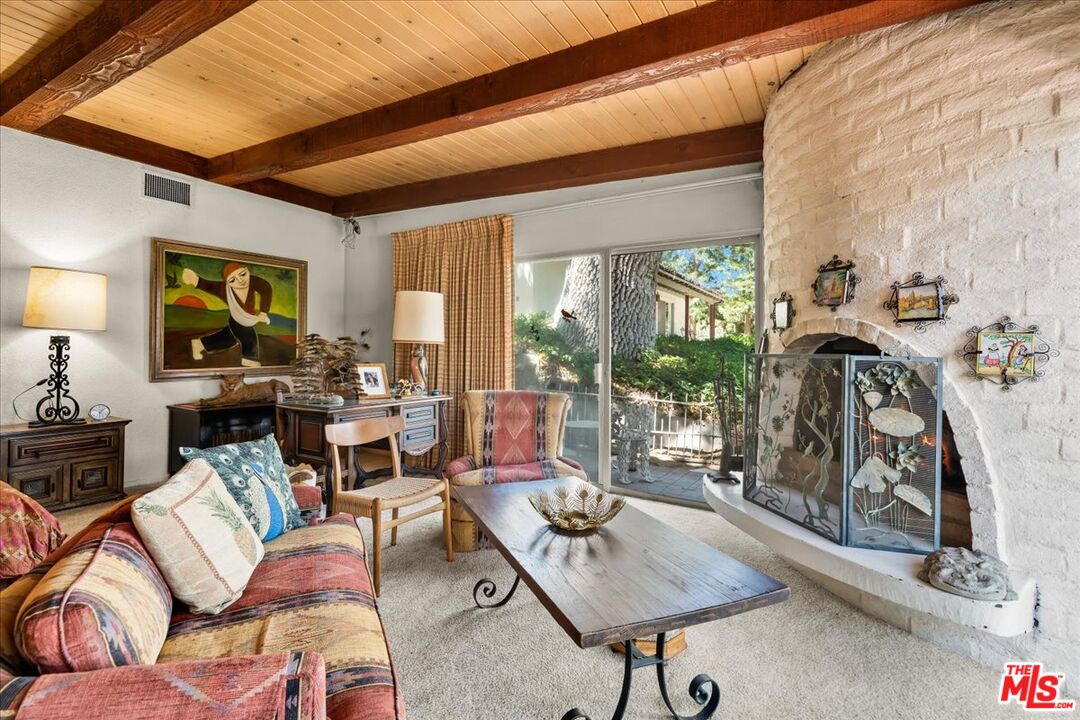 31008 Pine Canyon Road Lake Hughes, CA 93532 - Photo 12 of 29 a living room with furniture and a floor to ceiling window