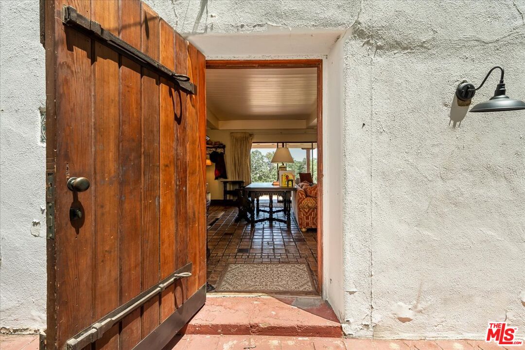 31008 Pine Canyon Road Lake Hughes, CA 93532 - Photo 15 of 29 a view of a hallway with a outdoor space