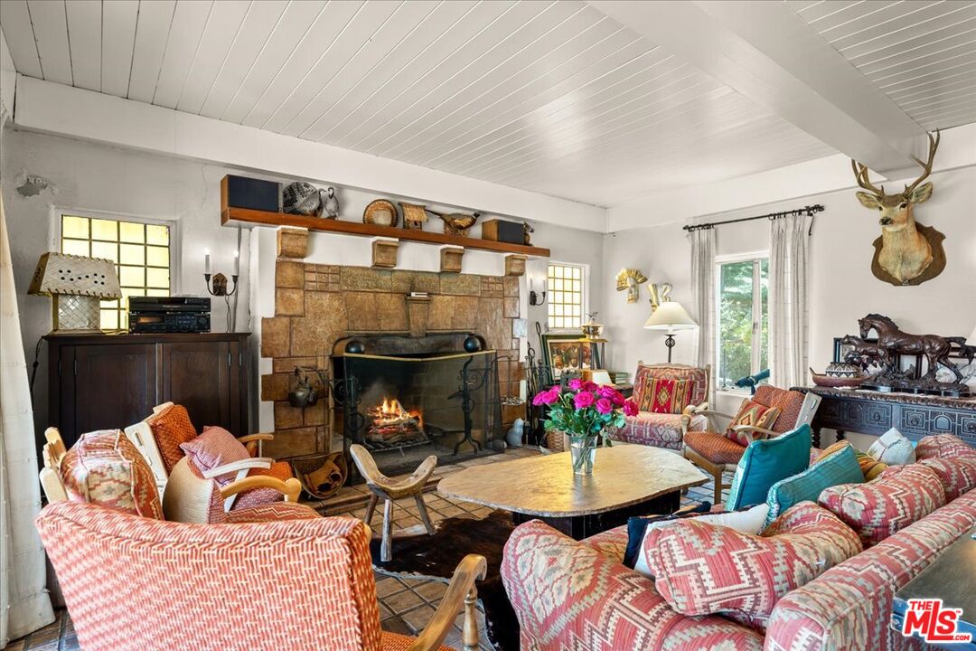 31008 Pine Canyon Road Lake Hughes, CA 93532 - Photo 5 of 29 a living room with furniture fireplace and a large window