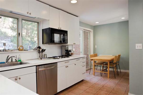 60 Beverly Road Brookline, MA 02467 - Photo 5 of 8 a kitchen with a sink dining table and chairs