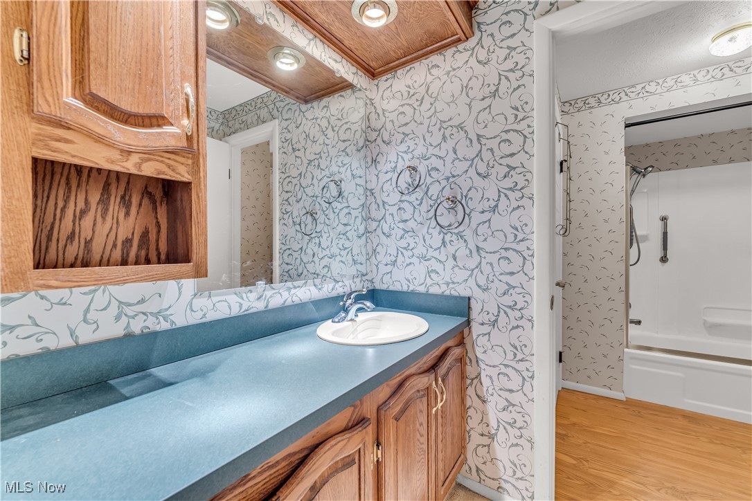 6470 State Road, Unit K5 Parma, OH 44134 - Photo 18 of 26 Full bath featuring vanity, wallpapered walls, shower / washtub combination, and light wood finished floors