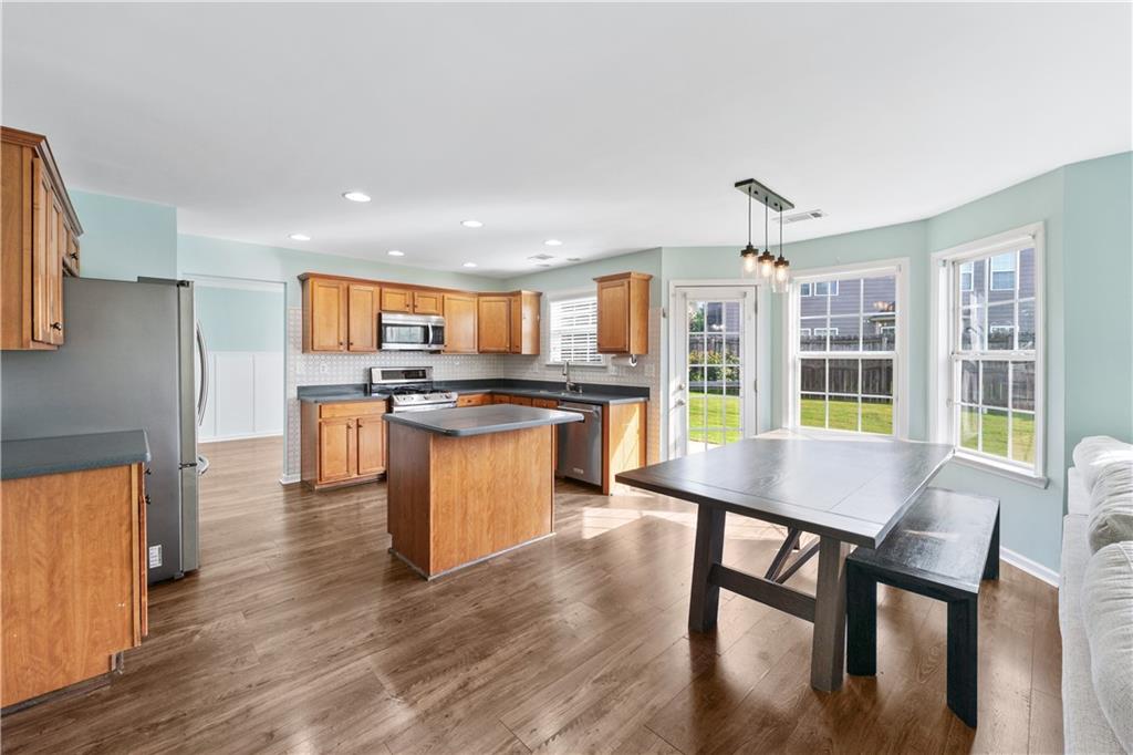 871 New Liberty Way Braselton, GA 30517 - Photo 12 of 47 a kitchen with stainless steel appliances granite countertop a stove top oven a sink and a refrigerator
