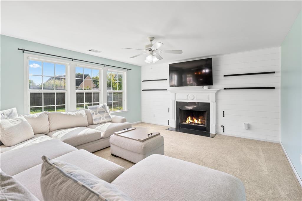 871 New Liberty Way Braselton, GA 30517 - Photo 13 of 47 a living room with furniture a fireplace and a flat screen tv