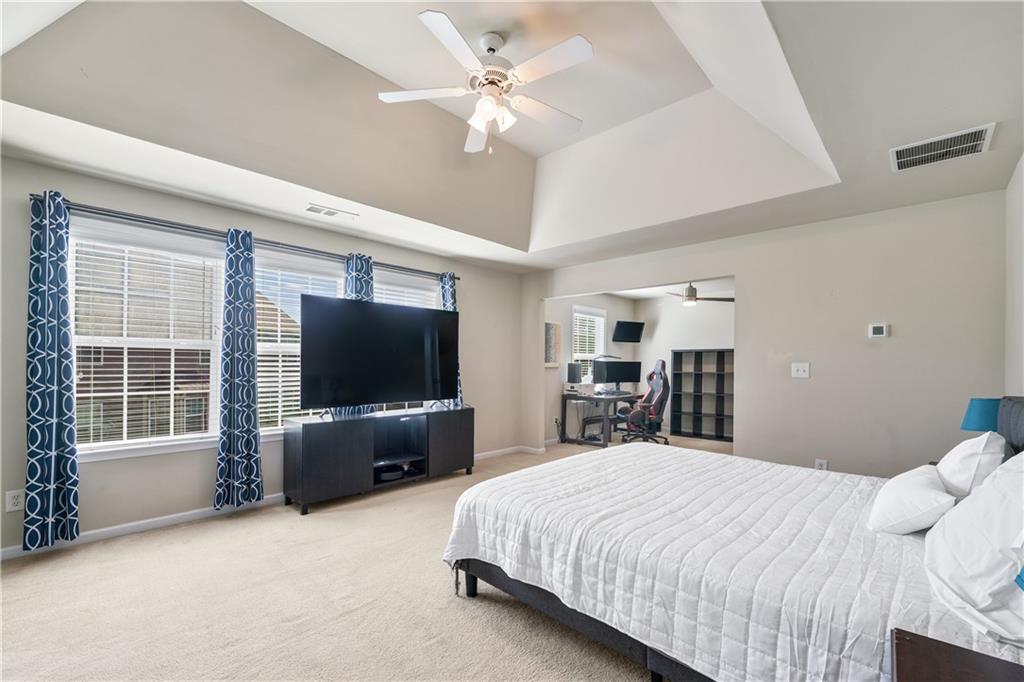 871 New Liberty Way Braselton, GA 30517 - Photo 22 of 47 a bedroom with a bed and a flat screen tv