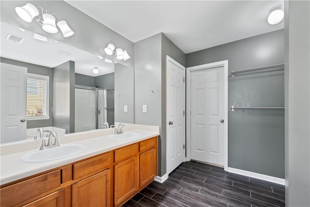 871 New Liberty Way Braselton, GA 30517 - Photo 24 of 47 a spacious bathroom with a double vanity sink mirror and shower