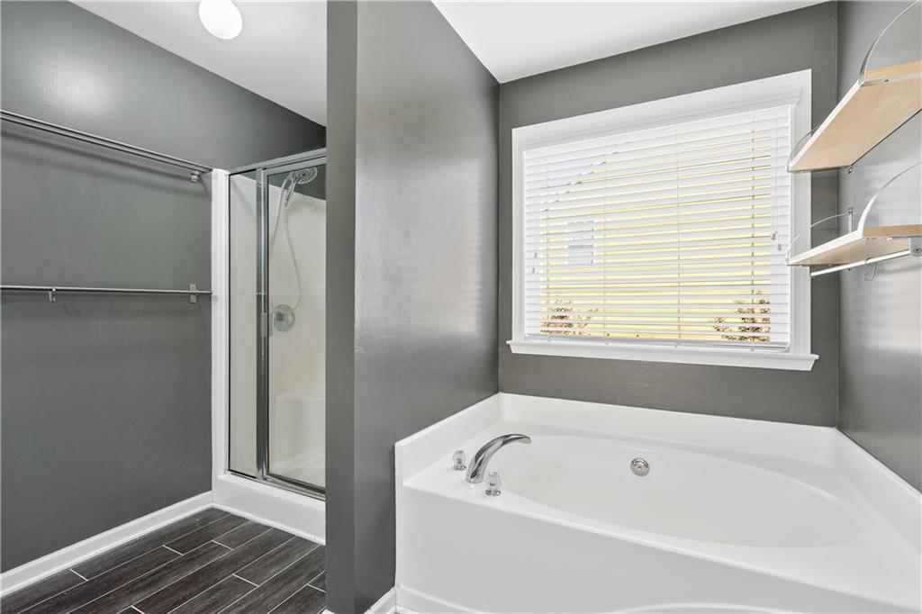 871 New Liberty Way Braselton, GA 30517 - Photo 25 of 47 a bathroom with a bathtub and a shower