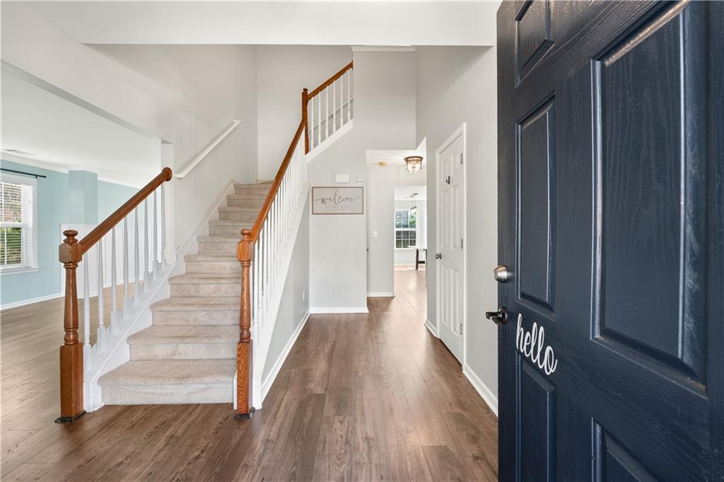 871 New Liberty Way Braselton, GA 30517 - Photo 3 of 47 a view of a hallway with wooden floor and staircase