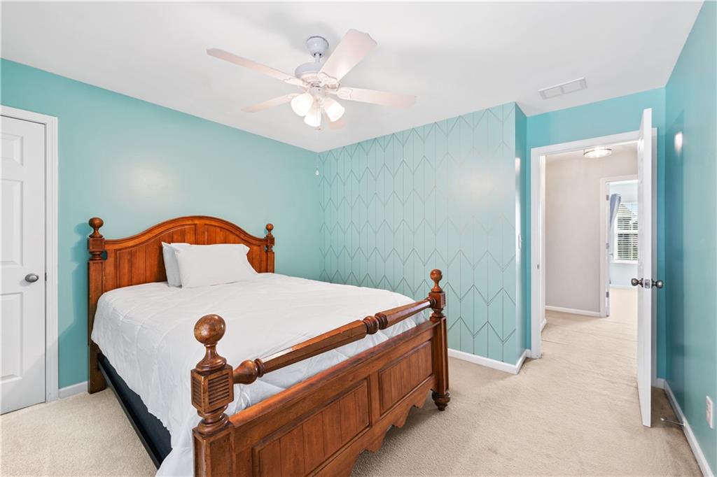 871 New Liberty Way Braselton, GA 30517 - Photo 31 of 47 a bed sitting in a bedroom next to a bathroom sink