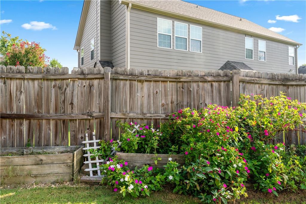 871 New Liberty Way Braselton, GA 30517 - Photo 35 of 47 a bunch of flowers are in front of a house