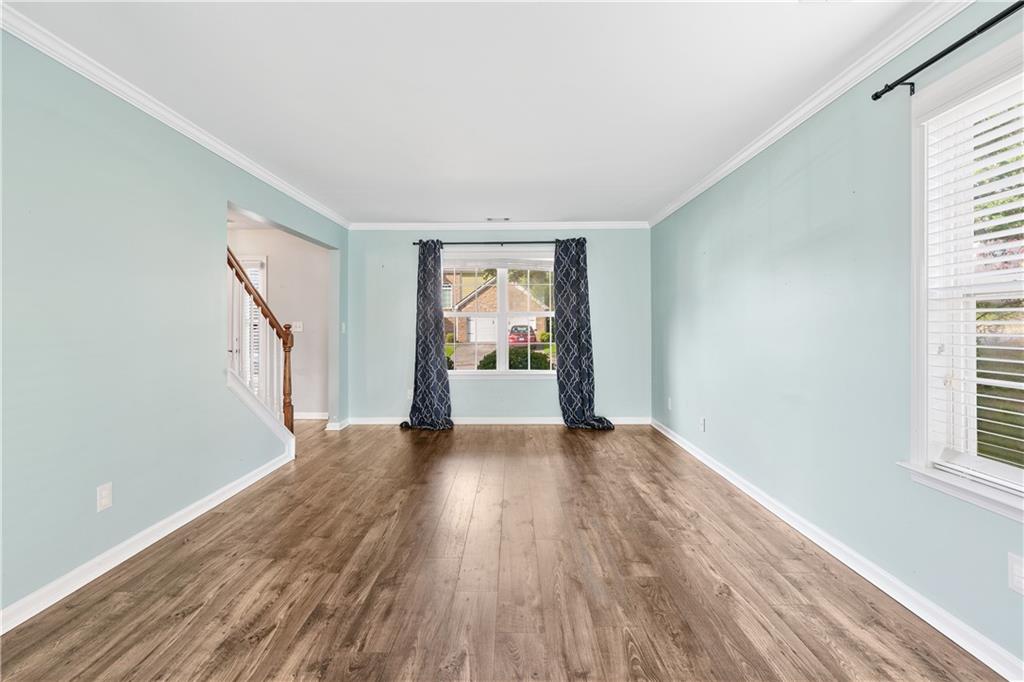 871 New Liberty Way Braselton, GA 30517 - Photo 4 of 47 a view of an empty room with wooden floor and a window