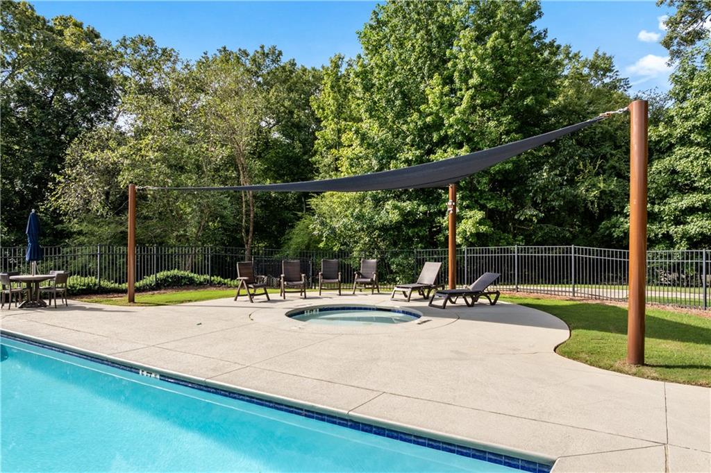 871 New Liberty Way Braselton, GA 30517 - Photo 45 of 47 a view of a swimming pool with a patio and fire pit