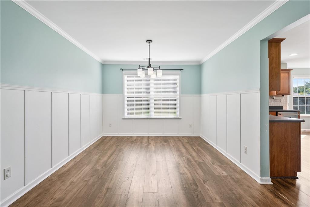 871 New Liberty Way Braselton, GA 30517 - Photo 6 of 47 wooden floor in an empty room with a window
