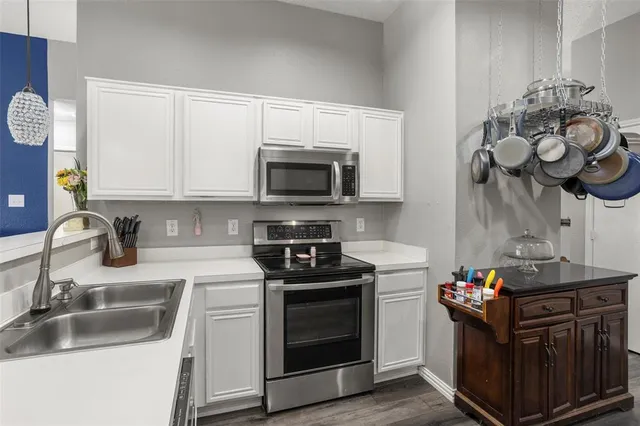 a kitchen with a sink stove and microwave
