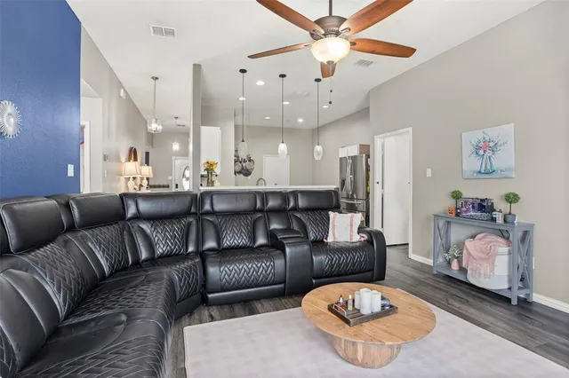 a large living room with a couch and a chandelier