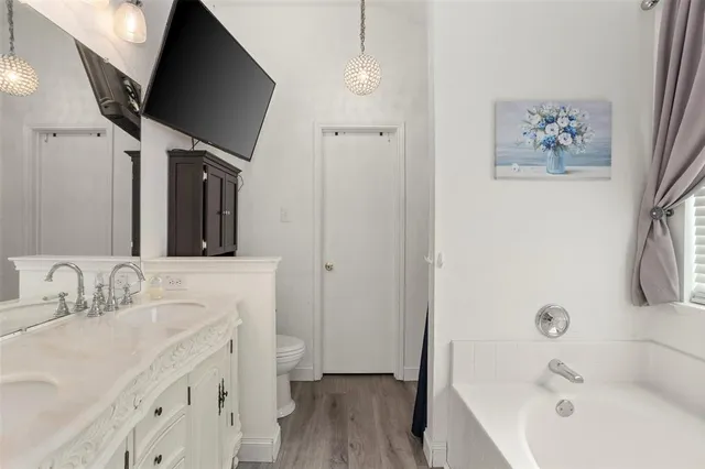 a bathroom with a tub sink and mirror