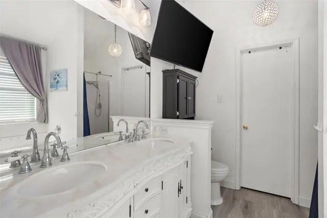 a bathroom with a double vanity sink and a mirror
