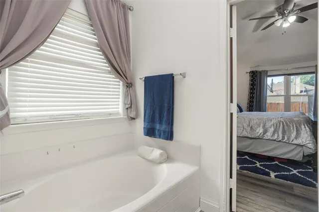 a bathroom with a bathtub and a window