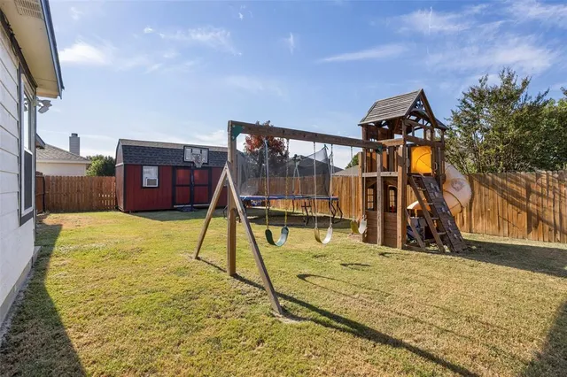 a backyard of a house with a small yard and wooden fence