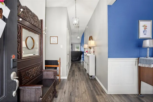 a view of a hallway with wooden floor and staircase