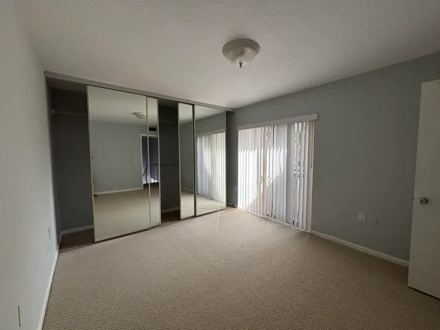 a view of bathroom with double vanity and a mirror