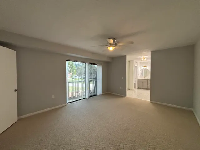 a view of a backyard with plants and wooden fence